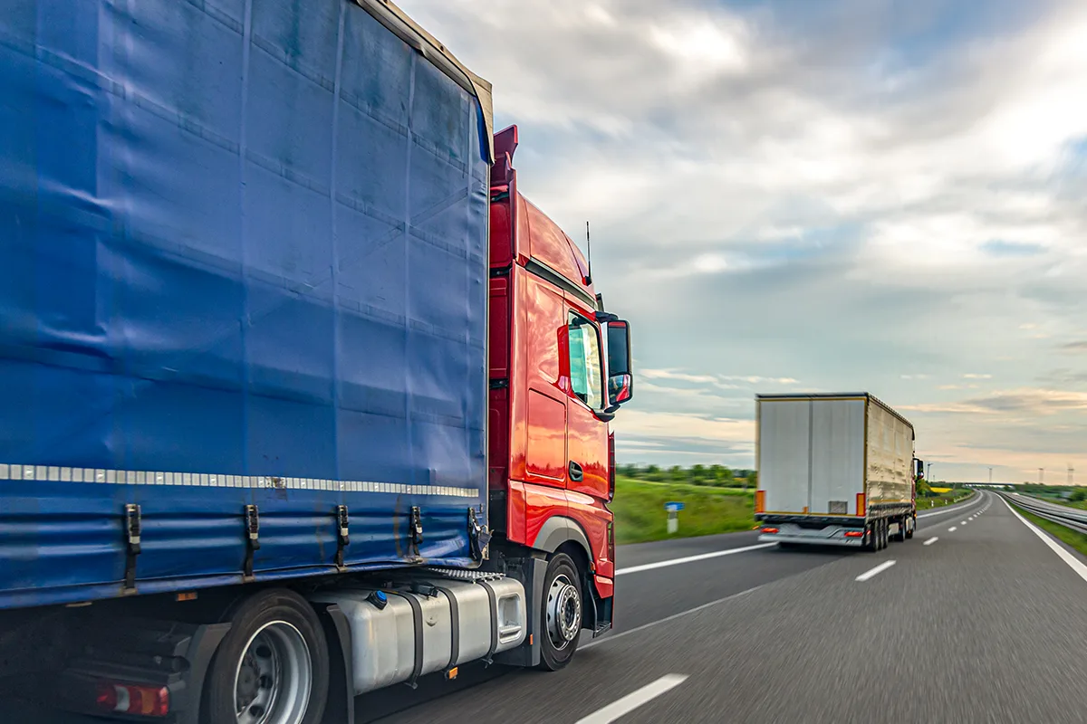 Freight-trucks-driving-on-highwa- logistics-and-road-Percy-transportation